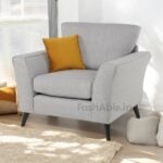 Enhance your space with the Mahir Lenka Fabric 3+1+1 Seater Sofa Set. A cozy light gray upholstered armchair features sleek black legs and a vibrant mustard-yellow cushion. Soft cushions and a beige rug complete the warm, inviting ambiance, offering ultimate comfort for your home.