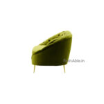Showcased in a side profile against a white background, the Hayat Velvet 2 Seater Modern Sofa features green plush upholstery with tufted detailing and sleek gold metal legs, inviting elegance and proving the perfect stylish addition to any space.