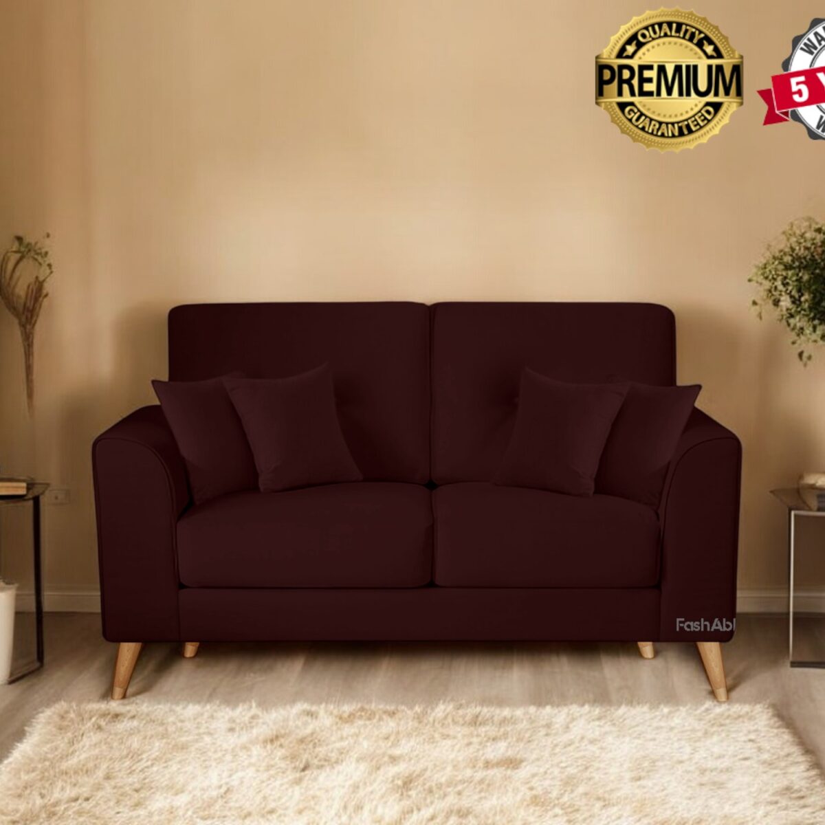 A cozy living room with a dark brown sofa adorned with two cushions invites you to explore its charm. The room features two potted plants, stacked books on a small table, and a beige rug. Banners proudly showcase Premium Quality and a 5 Years Warranty, enticing you to buy.