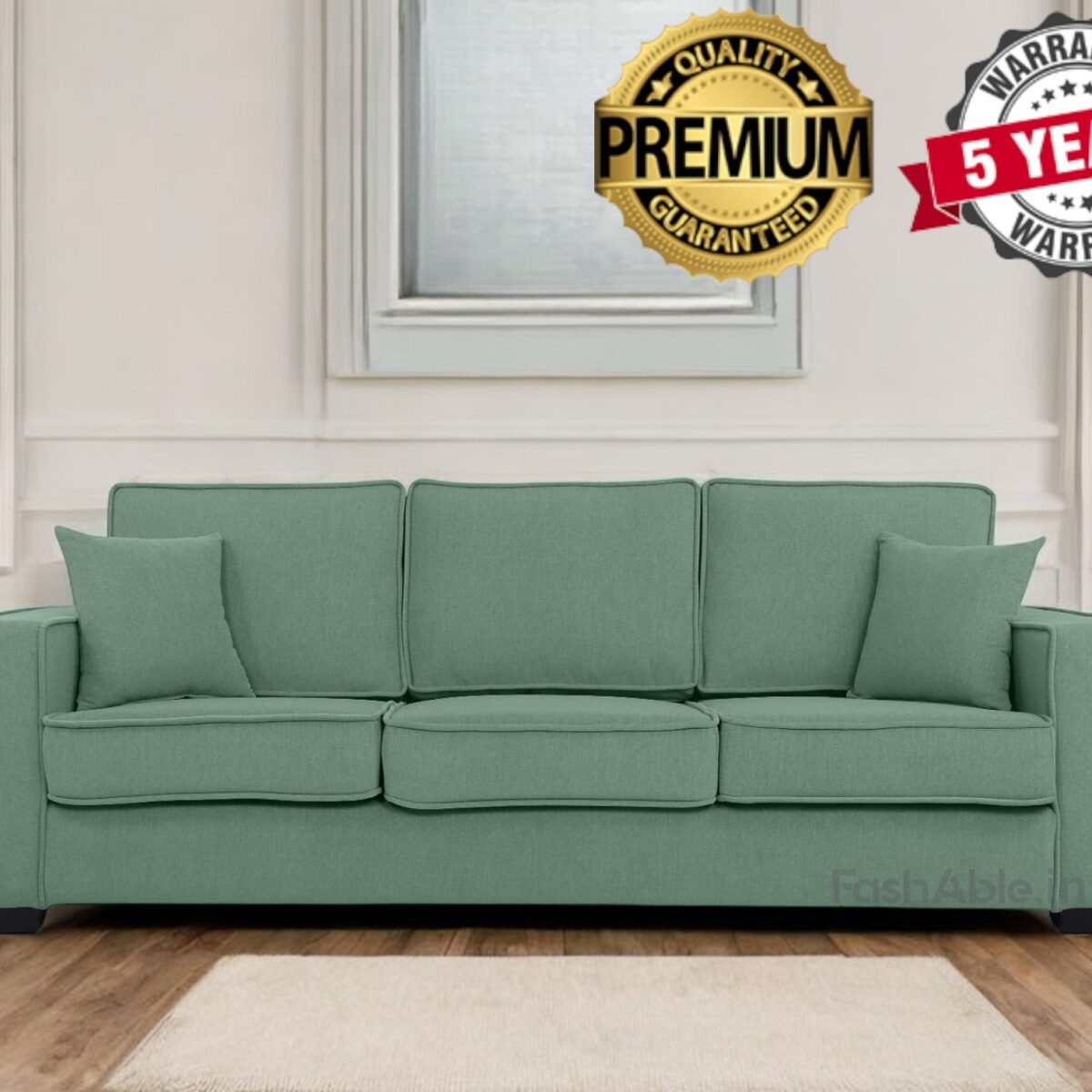 A green sofa with three large cushions and two smaller side cushions sits in a bright room with white walls, showcasing labels that read Premium Quality Guaranteed and 5 Years Warranty. Perfect for any fashable home decor, this piece transforms your living space into a stylish shop-like setting.