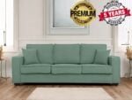 A green sofa with three large cushions and two smaller side cushions sits in a bright room with white walls, showcasing labels that read Premium Quality Guaranteed and 5 Years Warranty. Perfect for any fashable home decor, this piece transforms your living space into a stylish shop-like setting.