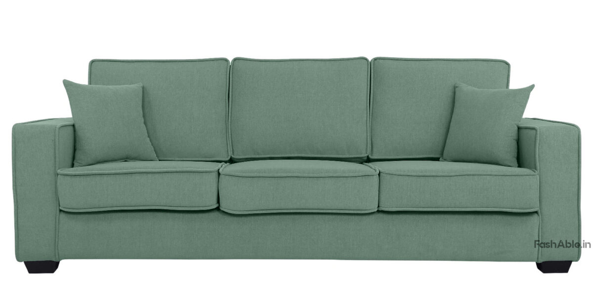 The Thea 3 Seater Mid-Century Sofa, 78, in green features square cushions and armrests with modern, clean lines. Two matching Fashable throw pillows enhance its stylish appeal, inviting you to explore comfort and elegance against a white backdrop.